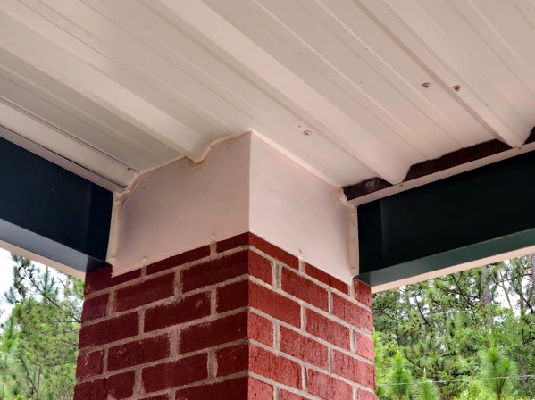 Close view of customized bird-control protection at a covered column and beam.